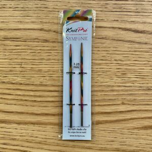 3.25mm knitting needle tips made from multi-coloured wood, packaged.